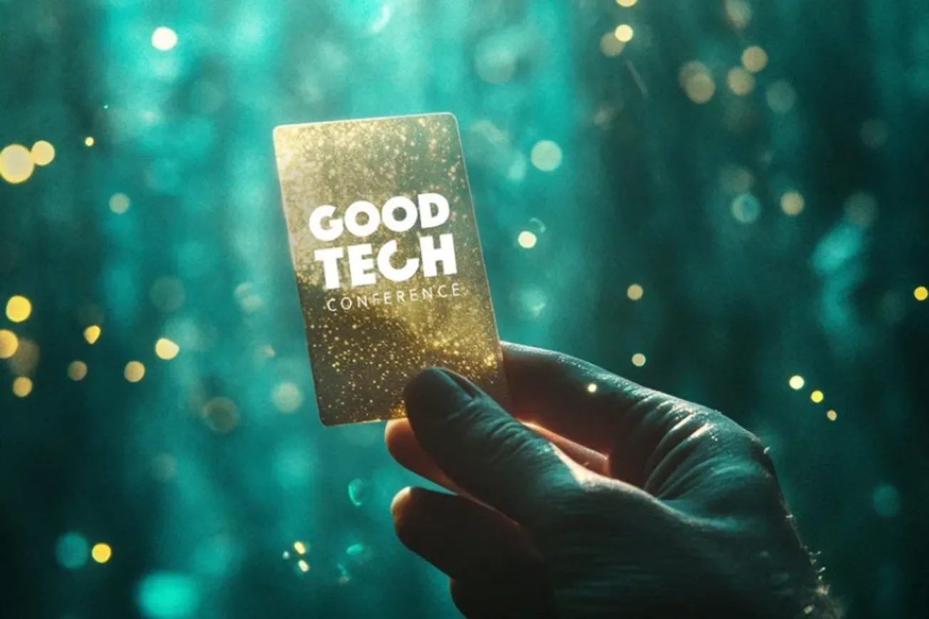 A hand holding up a card that says "Good Tech Conference" on it.